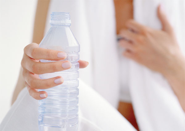 Woman Holding a Bottle of Water --- Image by © Royalty-Free/Corbis