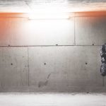 Young Man Standing In Front of Concrete Wall